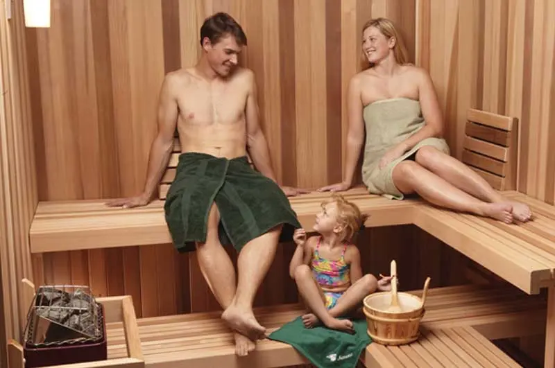 Couple with child in sauna