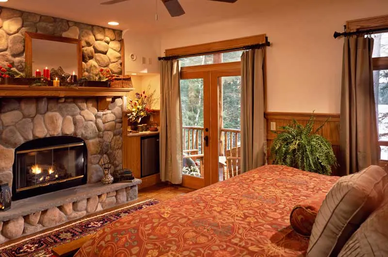 Bedroom with bed and stone fireplace