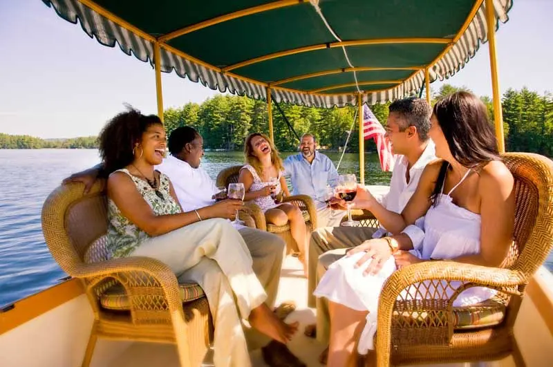 group having drinks on boat on the lake