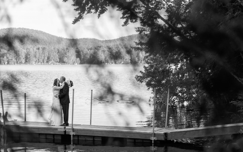 Bride and groom kissing on dock